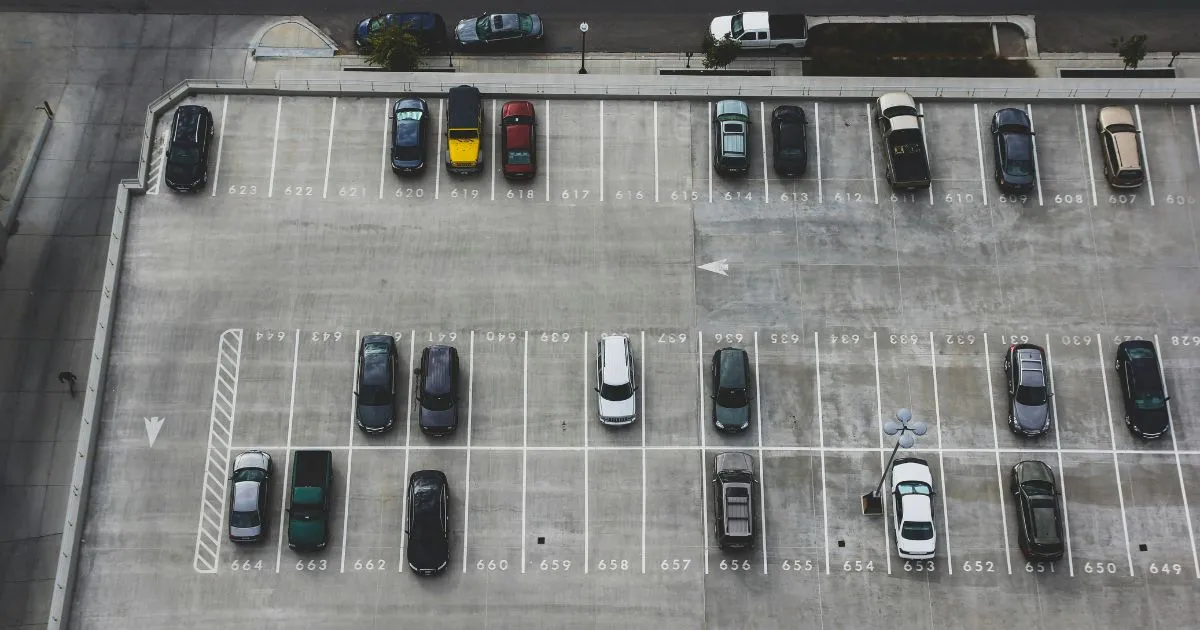 A Car Between Two Parked Cars Preparing To Parallel Park