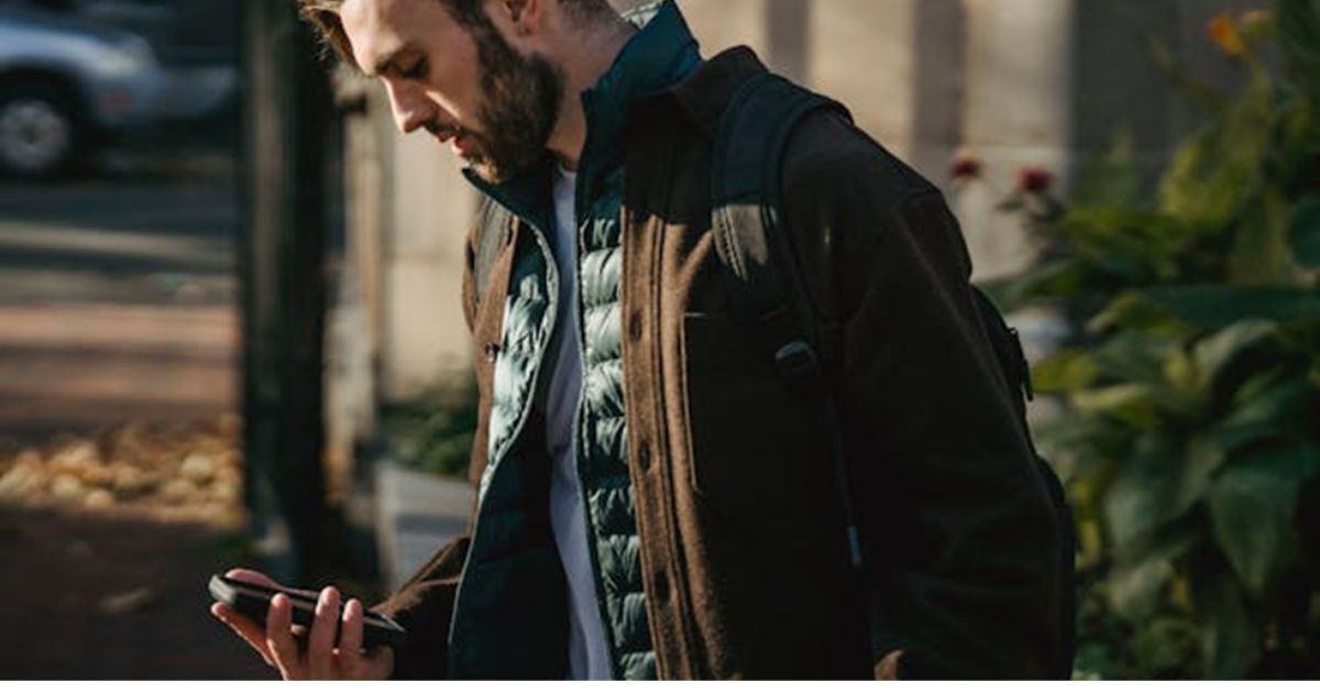 A man on the street with a phone in his hand