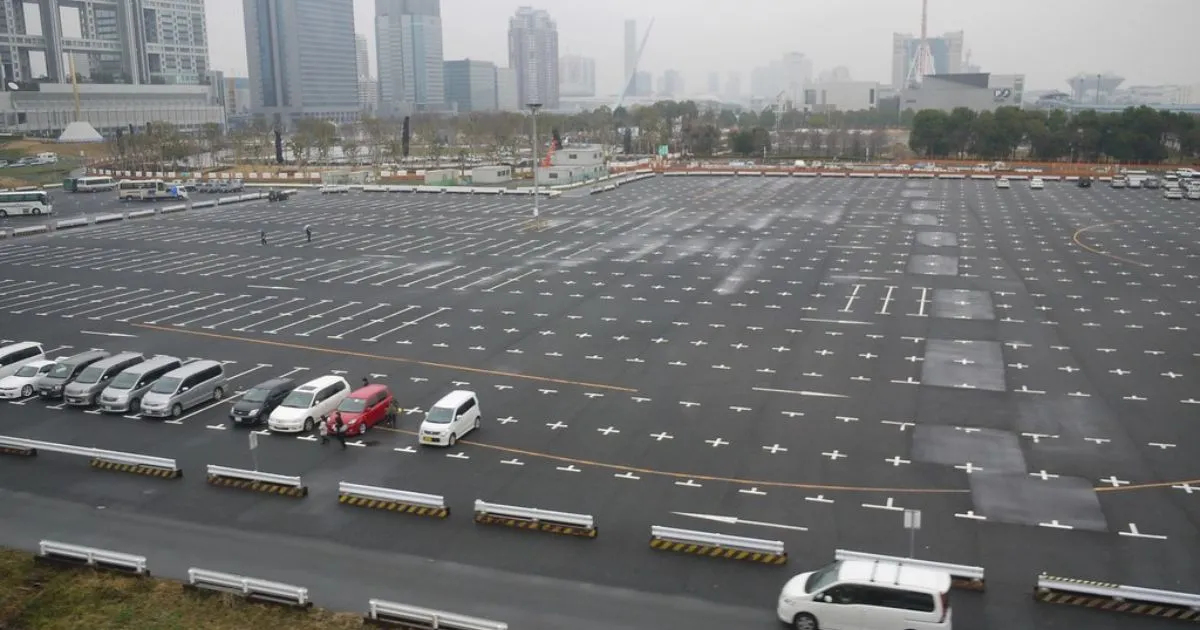 A Huge Parking Lot With Only A Few Occupied Spaces
