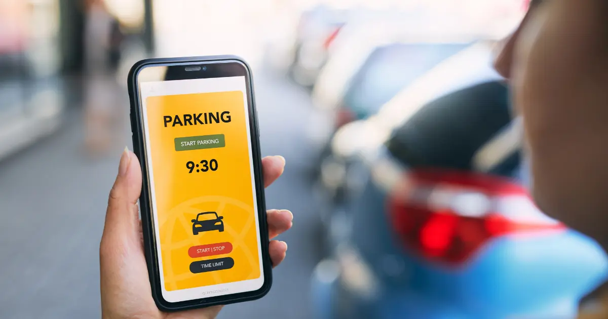 Lady Using Mobile To Book Parking Via An App