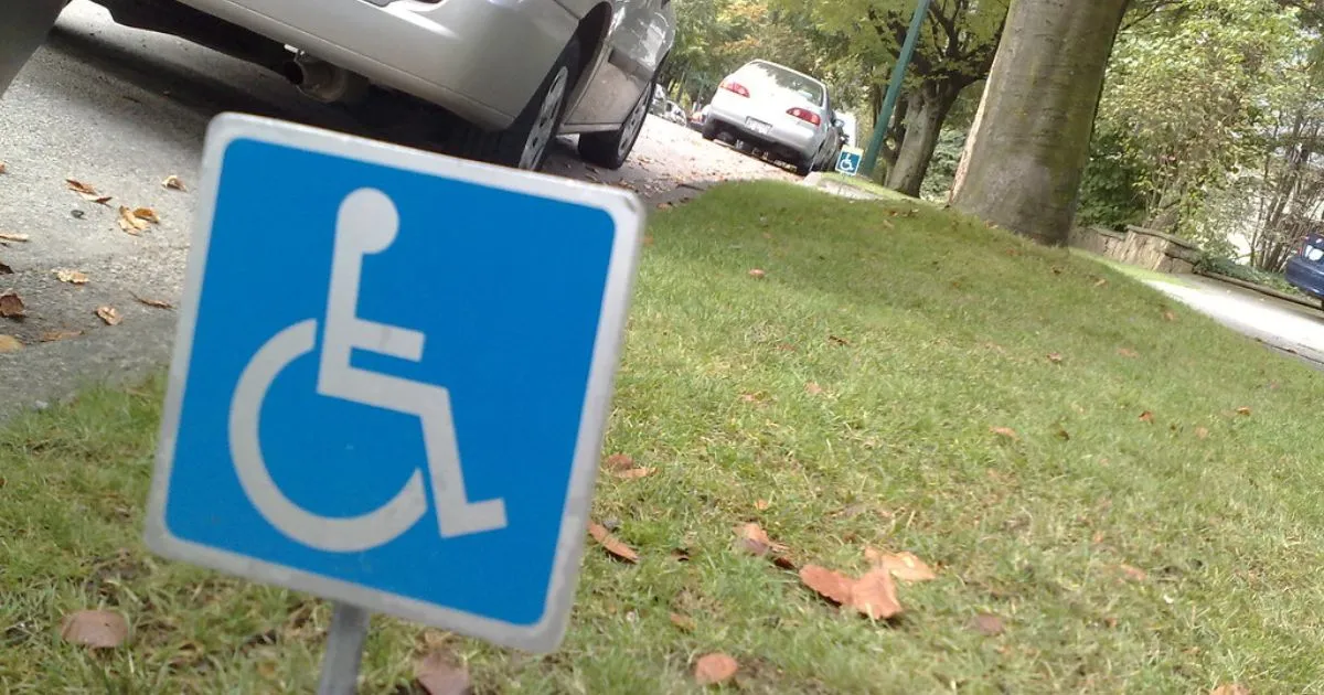 The Handicapped Parking Sign In A Parking Lot