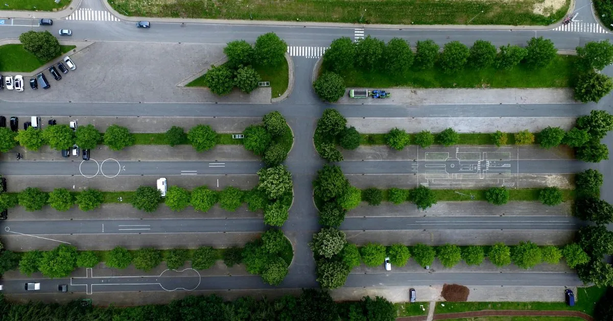 The Top View Of A Parking Lot With Various Trees Around