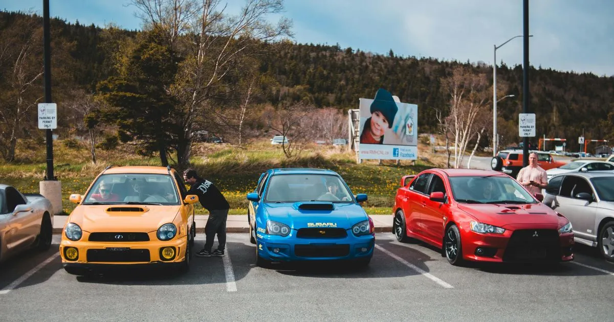 Vehicles Parked In A Spacious Parking Lot In A Mountain Region