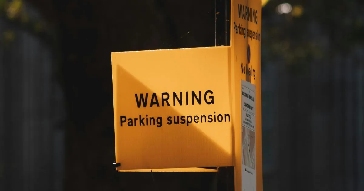 Warning Sign Of Parking Suspension Displayed On A Post
